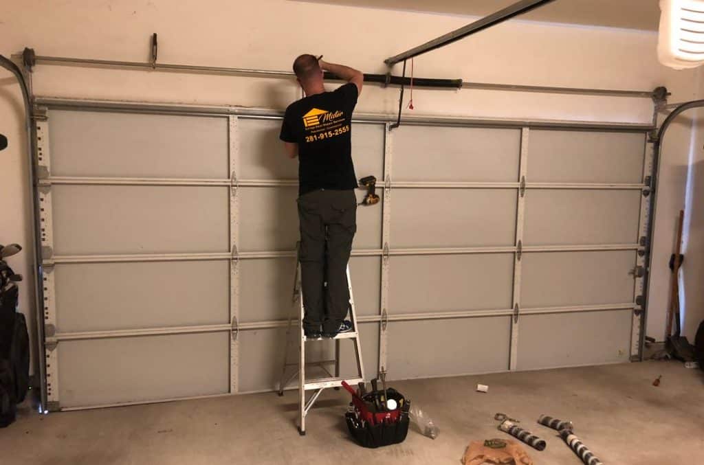 Mister Garage Door Repair Services technician repairing a garage door in Houston